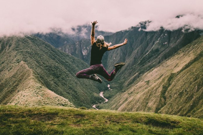 WomanJumpingMountains